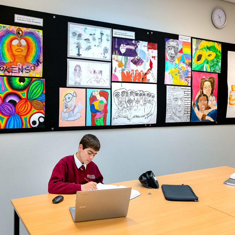 Students work in their sketchbooks during art lesson