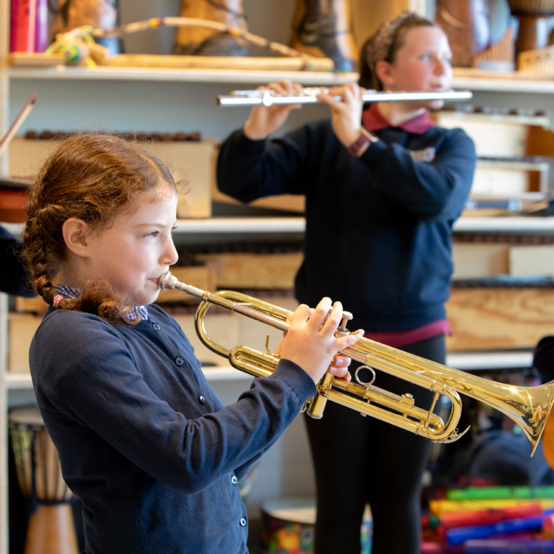 Students playing instruments in the music classroom