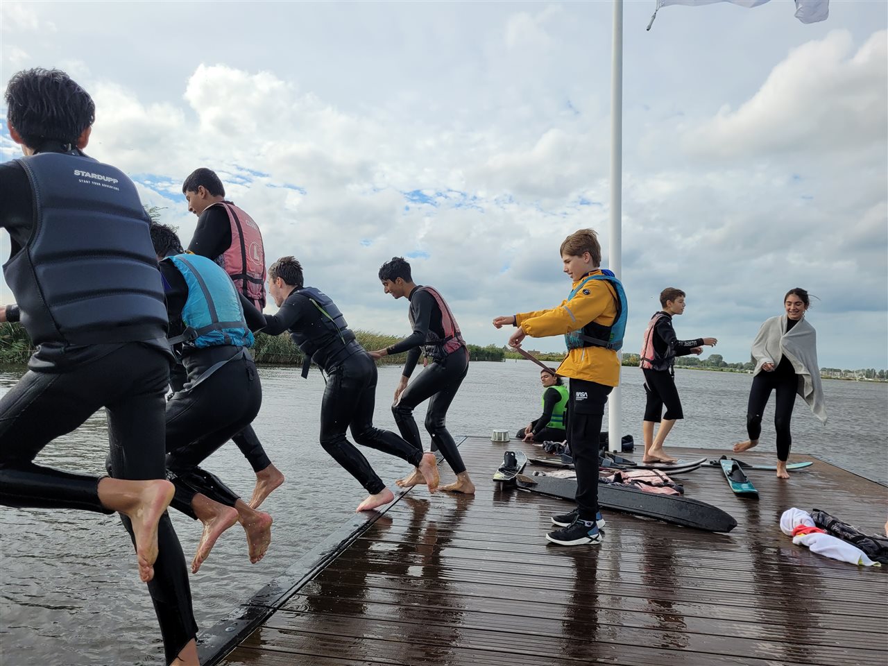 Senior students at the British School of Amsterdam playing and jumping into water